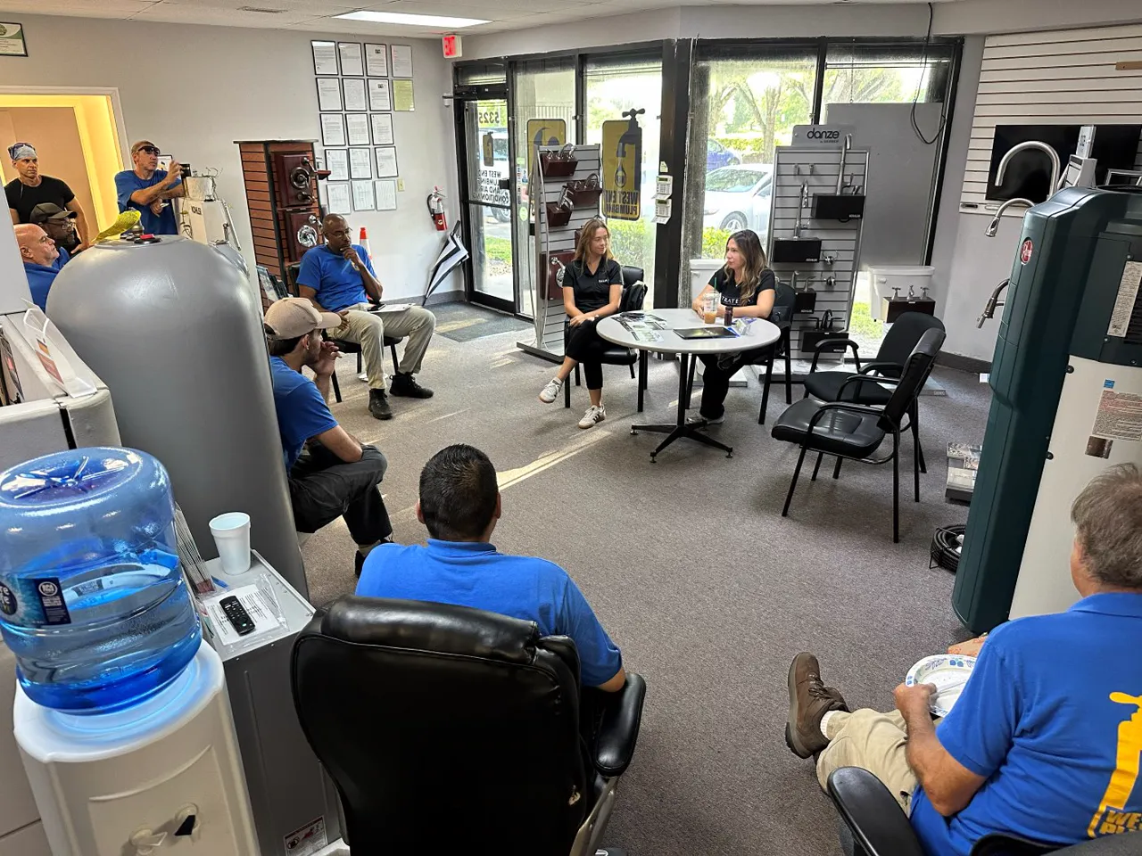 A team seated in a showroom during a training session